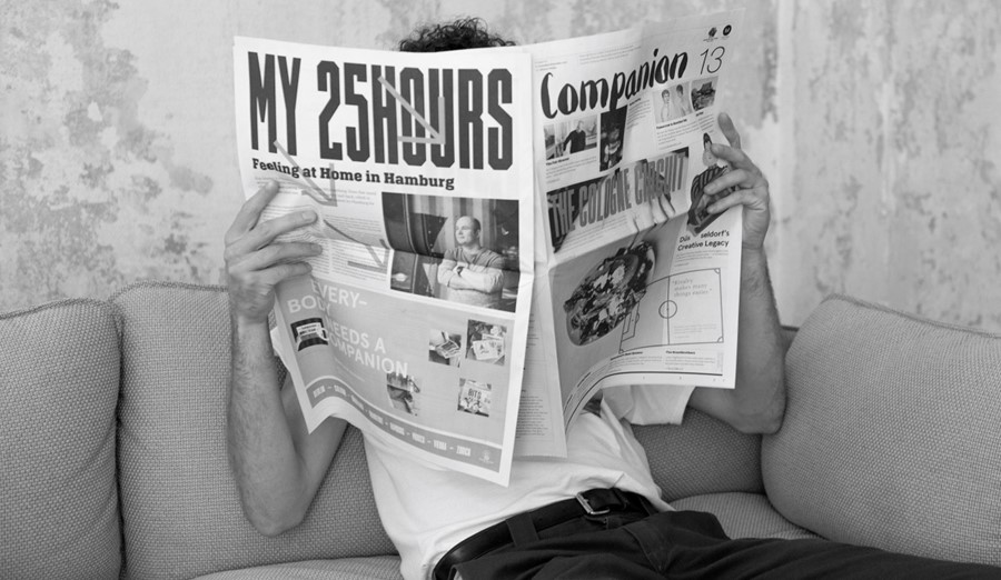Person reading the Companion magazine sitting on a couch