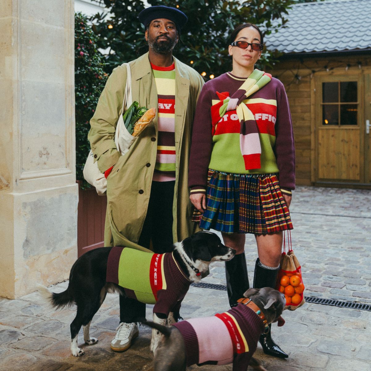 A couple and their dogs wearing matching Hox x Barc jumpers
